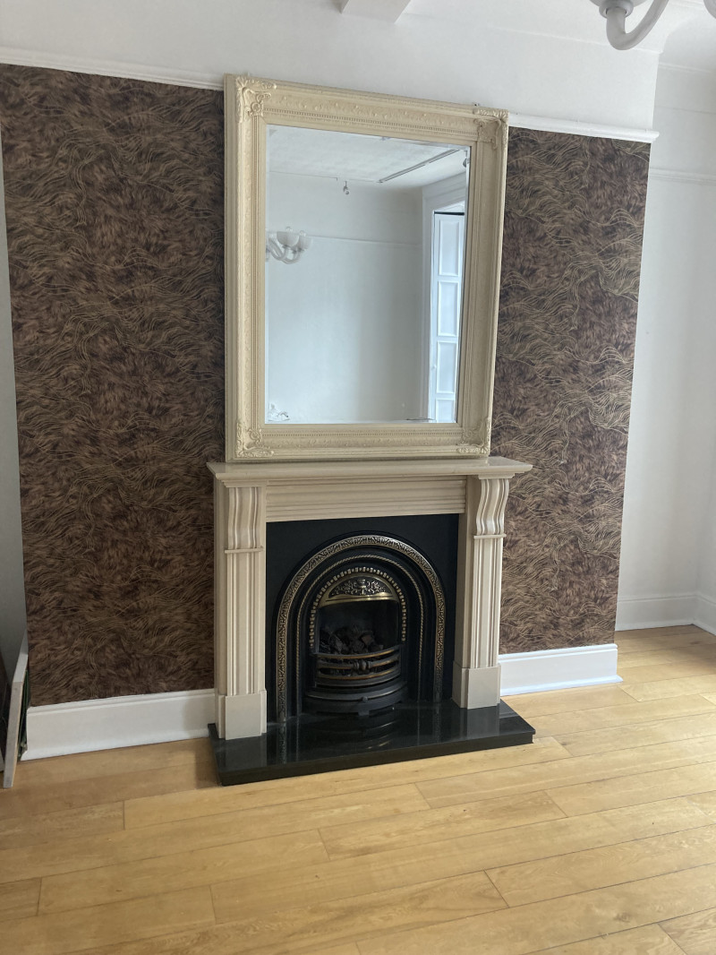 Wallpaper around a fireplace in a Dublin sitting room by Abhaile Decorators, Ireland