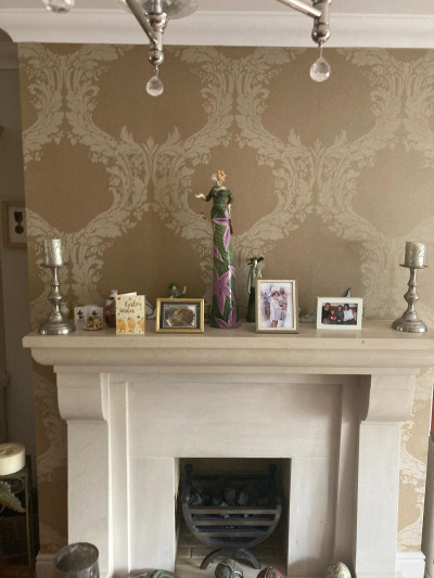 Wallpapering around a fireplace in a Dublin sitting room by Abhaile Decorators, Ireland